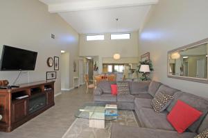a living room with a couch and a flat screen tv at VY236 - Sunny Palm in Palm Desert