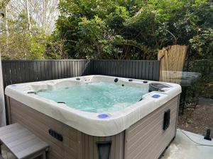 a jacuzzi tub sitting on a patio at Hunchy Hideaway in Montville