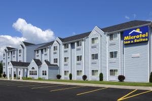 an exterior view of anadobe inn and suites at Microtel Inn & Suites by Wyndham Plattsburgh in Plattsburgh