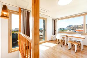 a dining room with a table and a large window at Joyuam Jeju in Seogwipo