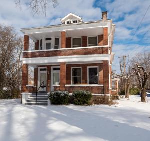 a brick house with snow on the ground at Updated 3 bedroom unit with balcony! in Cape Girardeau