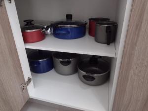 a pantry with pots and pans on a shelf at Hermosa casa en Acapulco con club de Playa. in Acapulco
