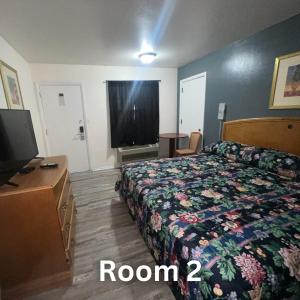 a hotel room with a bed and a flat screen tv at Nights Inn - Richfield in Richfield