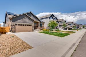 a house with a driveway in a residential neighborhood at Mead Vacation Rental Fenced Backyard and Fire Pit! in Longmont