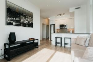 a living room with a couch and a table at Cozy & Contemporary Suite - Easy Access to Everything in Richmond Hill