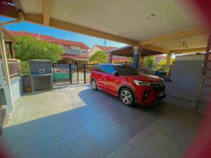 a red car is parked in a garage at Homestay FourSeasons @ Bandar Baru Bangi in Bandar Baru Bangi