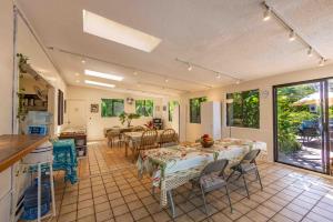 a kitchen and dining room with a table and chairs at Plumeria Room on a Lush Farm on Maui's North Shore in Huelo