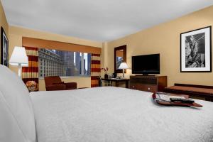 
a hotel room with two beds and a television at Hampton Inn Manhattan-Times Square North in New York
