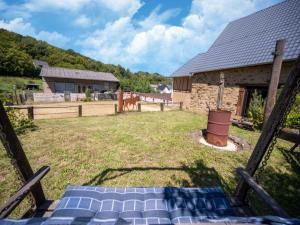 a yard with a fence and a house at Comfy holiday home in Roes with terrace in Roes