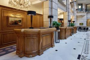 a lobby with a row of wooden stations in a building at Paris Marriott Champs Elysees Hotel in Paris
