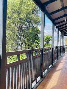 a wooden fence on a bridge with trees in the background at Belmore Hotel Scone in Scone