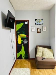 a room with a door with a couch and a wall at HOSTAL AMA in Leticia