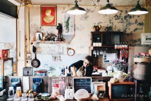 a man standing behind a counter in a coffee shop at ทุ่งยั้งเฮ้าส์ in Uttaradit