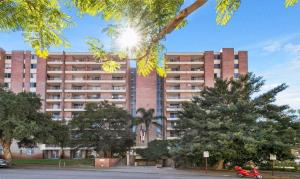 a building with a red scooter parked in front of it at Studio Apartment in East Perth in Perth