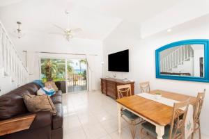 a living room with a couch and a table at Beach Living at Moon Bay with SeaView in Bodden Town