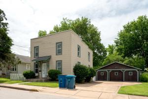 a house with two blue trash cans in front of it at 4 Bedroom House, sleeps 12, short walk to Main St! in St. Charles