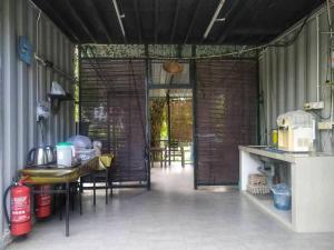 a kitchen with a table and chairs in a room at LeThuHouse in Malacca