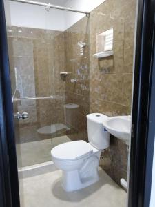 a bathroom with a toilet and a sink and a shower at HOTEL LA CASONA in Tauramena