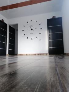 a large clock on a wall in a room at HOTEL LA CASONA in Tauramena