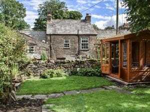 an external view of a stone house with a garden at Greystones in Ravenstonedale