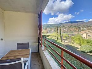 a balcony with a table and a view of the countryside at Appartement Lamalou-les-Bains, 2 pièces, 2 personnes - FR-1-451-154 in Lamalou-les-Bains