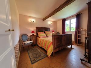 a bedroom with a bed and a chair and a window at Gîte Martincourt, 4 pièces, 6 personnes - FR-1-526-13 in Martincourt