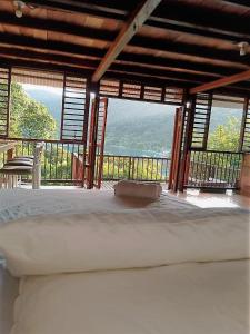 a bedroom with a bed with a view of the ocean at Cabana El Caney in Zapzurro +10 photos