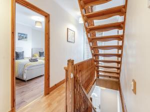 a stairway leading to a bedroom with a bed at Bradford House in Garnant