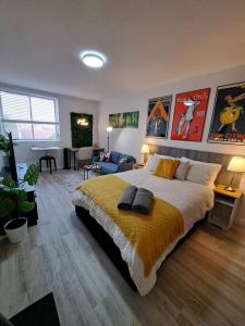 a bedroom with a large bed and a living room at Studio Apartment in East Perth in Perth