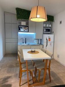 a kitchen with a table and chairs in a kitchen at Refugio Madryn relax in Puerto Madryn
