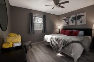 a bedroom with a bed and a ceiling fan at Luxurious 2-Bedroom Abode with Elevated Comforts Near Main Street in St. Charles