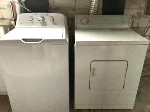 a white stove and a refrigerator next to a sink at The House Hotels - Cohasset Lower in Lakewood