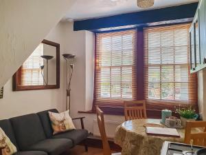 a living room with a couch and a table at Market Place in Workington