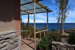 a view of the ocean from a house at Allpaluxe Peru Lodge in Amantani