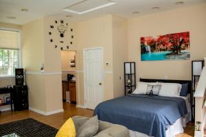 a bedroom with a bed and a painting on the wall at Sandy's Place in East Stroudsburg