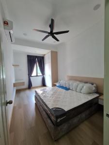 a bedroom with a bed and a ceiling fan at SS Muar in Muar
