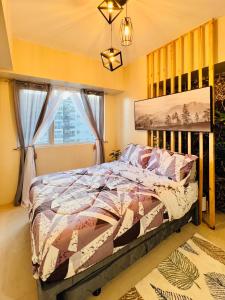 een slaapkamer met een bed en een raam bij * *P Fantastic 2BR Option for 8 in Iloilo City