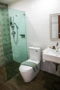 a bathroom with a toilet and a shower and a sink at Vera Costa Hotel in Nong Khai