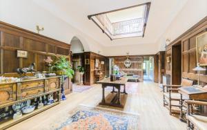 a large living room with a table and a skylight at North Ormsby Manor in Louth