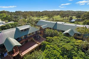 an overhead view of a building with trees in the background at Byron Links Apartments in Byron Bay