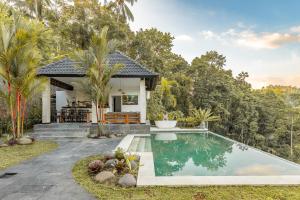 a villa with a swimming pool and a house at Sunrise Villa in Payangan