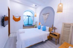 Postel nebo postele na pokoji v ubytování Nest House Homestay