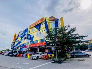 a yellow and blue building with cars parked in a parking lot at Sun Inns Hotel Cheras - Balakong in Cheras