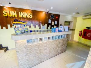 a restaurant with a counter with sun linens on it at Sun Inns Hotel Cheras - Balakong in Cheras