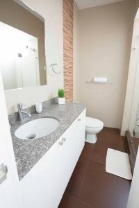 Baño blanco con lavabo y aseo en MLA apartments - Larcomar, en Lima