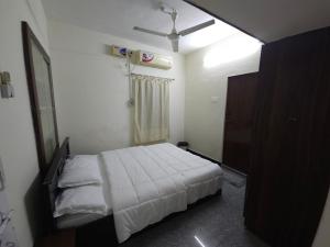 a bedroom with a bed and a shower in it at Happy Home in Coimbatore