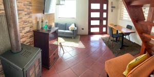 a living room with a tile floor with a stove at HOsTAL PALMED in Concepción
