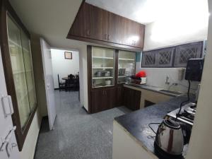 a kitchen with wooden cabinets and a counter top at Happy Home in Coimbatore