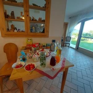 a wooden table with food on it in a kitchen at Agritur Maso Spezial in Villa Lagarina