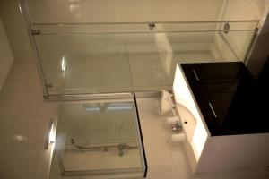 a glass shower in a bathroom with a sink at La Maison d'Hotes de Saint Leger in Saint-Léger-en-Yvelines